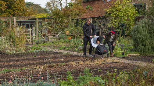 A family walking in the Ornamental Vegetable Garden in November at Osterley Park and House, London.